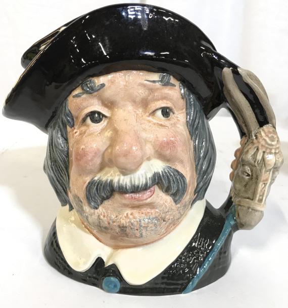 DOULTON & CO LTD SANCHO PANCA Porcelain Mug: Underside of piece is marked DOULTON & CO LTD. Piece depicts a long haired male figure with a mustache wearing a hat. Piece measures approx 7 inches tall 8 inches wide with handle. toby mug, collectib