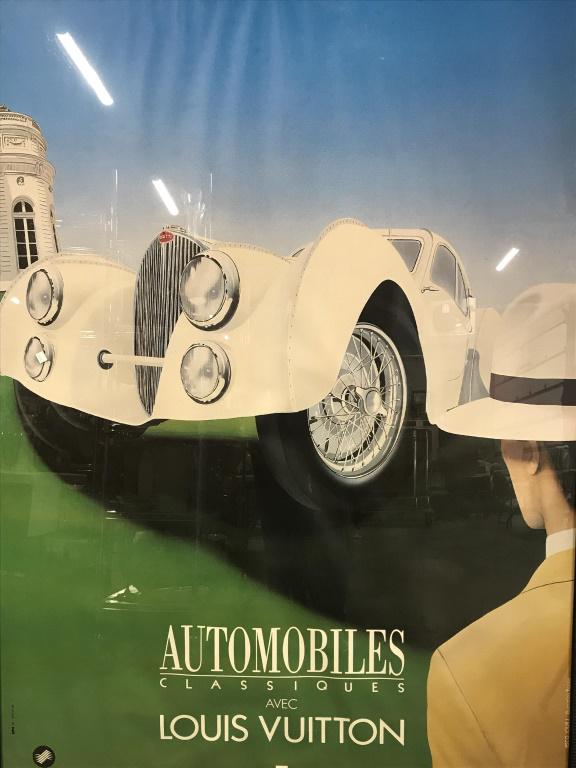 Oversized Louis Vuitton Poster by Razzia: Oversized Art Deco Poster Print by Razzia for ‘Automobiles Classiques Avec Louis Vuitton.’ Poster depcits dapper man looking at a Bugatti automobile. Type along bottom reads ‘avec la participati