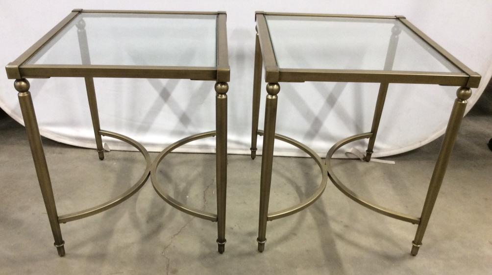 Pair Gold Toned Metal Glass Top Side Table: Side tables have glass top. Pieces have gold toned metal frames, possibly brass. Pieces have spherical detail directly under tabletop. Pieces have c curve detailed stretchers. Each measures approx 26