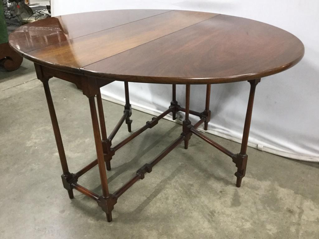 Antique Walnut Toned Wooden Gate Leg Table: Antique Table is wooden and Walnut toned. Table has delicate gate legs. Piece has 2 drop leafs. Measures approx 46 inches long 35 inches wide 24 inches tall. Multi purpose side table, end table, night