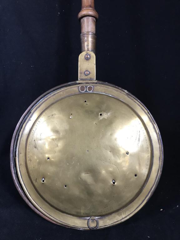 Antique Brass Toned Bed Warmer: Antique Brass Toned Bed Warmer with turned wooden handle, dents and rust to underside of pan, chips to wood handle, measures approximately 43 inches long x 11.5 in diameter x 3.25. Antique Bedwarmer, 