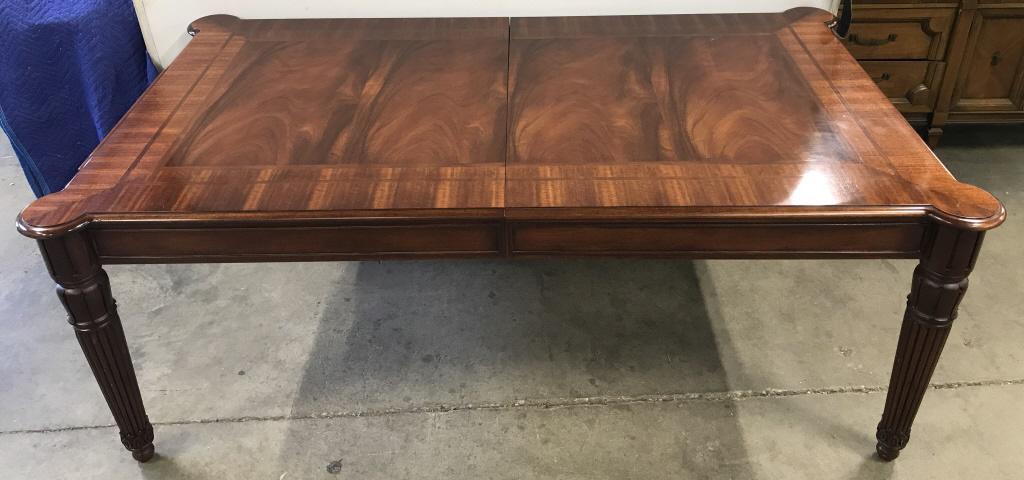 Ralph Lauren Flame Mahogany Dining Table: Ralph Lauren Flame Mahogany Dining Table With Carved legs, two lined drawers with brass toned drawer pulls for silverware storage, and two extension leaves. Measures approx 80 inches long x 48 inches 