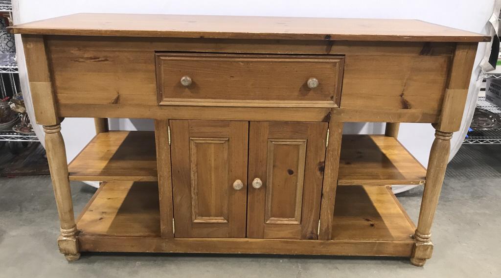 Handmade Pine Sideboard Cabinet: Piece appears to be handmade. Sideboard is Pine. Piece has 1 Drawer and 2 cabinet doors. Piece contains shelf on each side & 1 shelf inside cabinet space. Piece measures approx 60 inches long 36 inche
