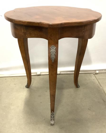 Vintage French Style Wood Table W Ormolu Accents: Vintage French Style Wood And Gilt Metal Occasional Table. Mahogany Toned wooden table with three cabriole legs and gilt metal leaf accents, measures approx 28.25 inches tall x 25 inches in diameter. 