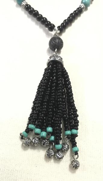 Ralph Lauren Tassel Pendant Turquoise Black Bead: Necklace. 10 turquoise beads, app 5 mm, black beads & Silver tone embossed beads strung on necklace with seed beaded tassel pendant. Necklace app 18 in. Tassel hangs 2.5 in. Designed for the Ralph Lau