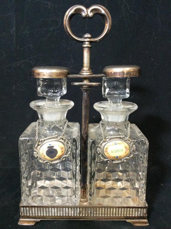 Cut Crystal Decanters In Silver Plated Holder: Lot includes 2 cut crystal Decanter, 2 Decanter labels, & 1 silver plated holder. Holder measures approx 13. 5 inches tall 8 inches wide, 4 inches deep. Each Decanter includes stopper. bar ware, table