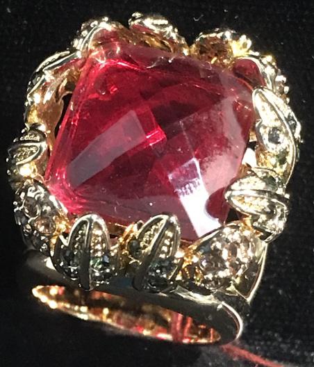 Adrienne Vittadini Statement Crystal Cocktail Ring: ring with ruby/ rubelite center stone, checkered cut with upper shaft crystals in colors of blue, orange in gold tone finish. Center stone measures 3/4 in. by 5/8 in. Upside down horse shoes on sides.