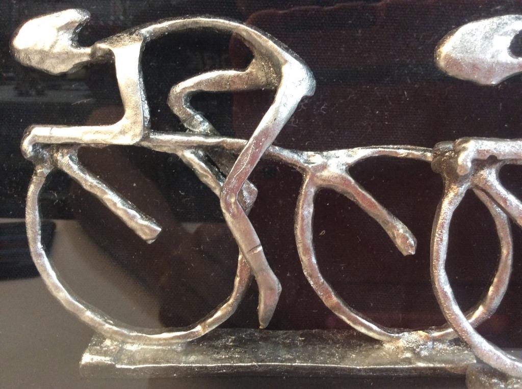 MERCANA Framed Metal Cyclists Figurals: Figurals are professionally framed with black toned frame. Pieces appear are silver toned and appear to be Pewter. Piece measure approximately 27.5 inches long 14 inches tall. home decor, fine art, ho