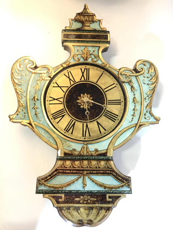 Vintage Ornately Detailed Wall Clock: Wall clock is vintage possibly antique. Contains intricately painted ornate detail. Contains tones of gold, celadon, black, & brown. Piece has glass structures on front of piece on top of painted area