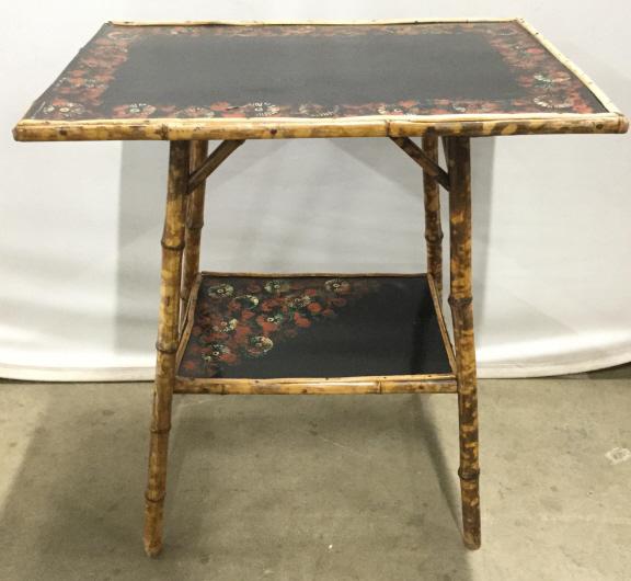 Antique Hand Painted Bamboo Style Table: Table is antique. Piece has hand painted floral detail around edges. Legs and table edges are possibly bamboo. Piece measures approx 26 inches tall 24 inches wide 16 inches deep. One table edge has po
