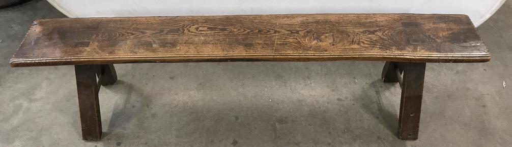Antique Rustic Farmhouse Wooden Bench: Antique Rustic Wooden Farmhouse Bench with heavy plank top, possibly hand planed and carved, chips scratches and some damage to base legs due to age and use, measures approximately 66 inches long x 10