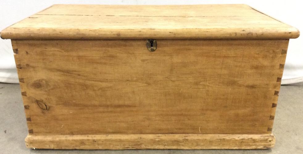 Antique Brushed Pine Chest: Antique brushed pine chest. Features dove tail joints. The handles appear to be made of iron, the interior hinges are also crafted from metal. Key to the chests lock is not included. Some wear is pres