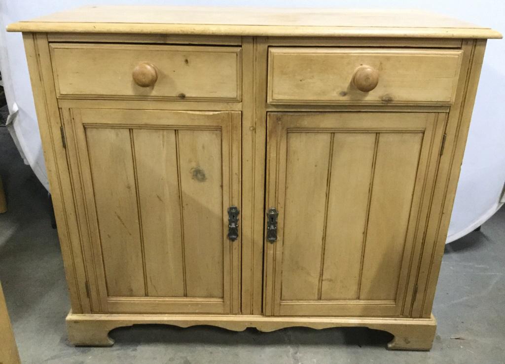 Vintage Scrubbed Pine Sideboard: Antique brushed pine chest. Features dove tail joints. The handles appear to be made of iron, the interior hinges are also crafted from metal. Key to the chests lock is not included. Some wear is pres