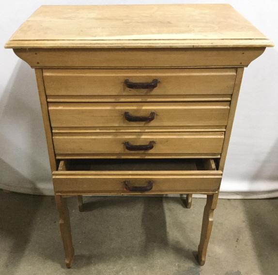 Antique Scrubbed Pine Drop Front Filing Drawer: Front of drawers drop downward. Handles of drawer are possibly Bakelite. Piece is scrubbed Pine. Contains 4 drawers. Lowest drawer contains 2 legs which drop. As Drawer is pulled out. Antique drawer, 