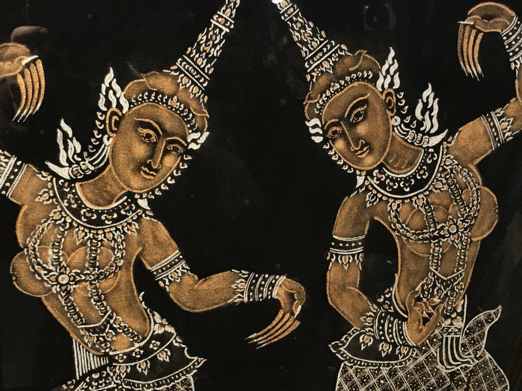 Thai Painting on Black Silk Tapestry: Hand-painted black silk tapestry of twin Thai Buddhist goddess Parvati. Tapestry is set behind glass in wood frame. Measures approx 21 inches in height by 19 inches in width with frame. Minor blemishe