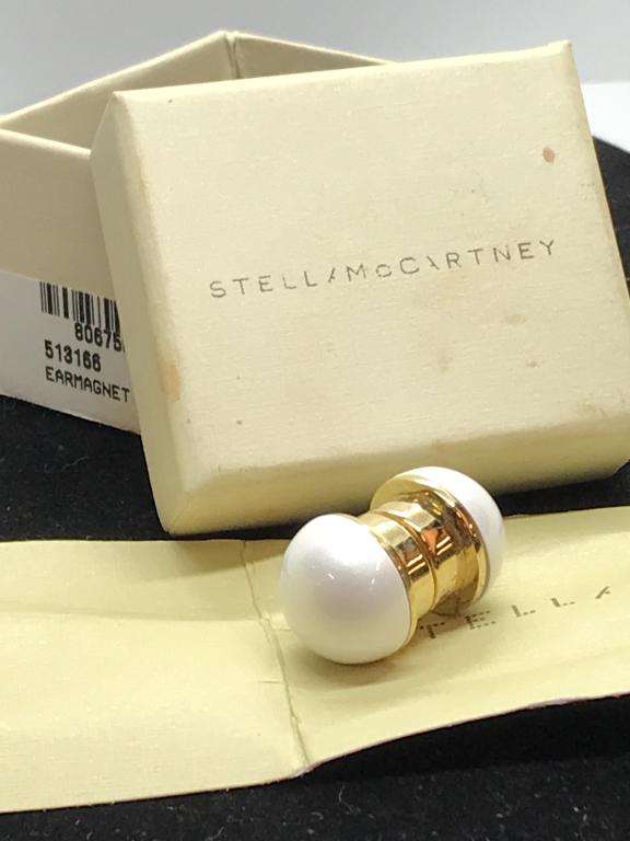Stella McCartney Brass Magnet Earrings, Org. Box: Pearl Style Ear Magnet, Signed brass that reads ‘Stella McCartney Made In Italy’. 5/8 in. diameter. Authenticity Paper label with style numbers and labels the metal as brass. Ear Magnet, Fashion A