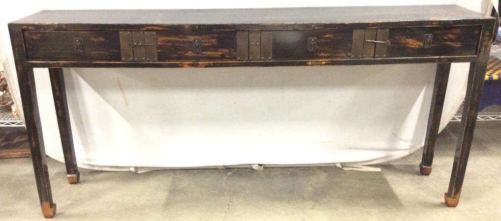 Vintage Asian Lacquered Console Table: Piece is vintage possibly antique. Console table is black toned and wooden. Piece has Lacquered finish. Piece has 4 carved wooden feet. Console table includes 4 drawers & 2 metal drawer stopper locks.