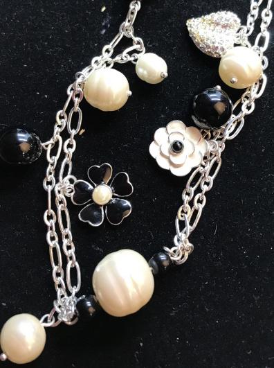 Carolee Mixed Element Long Fashion Necklace: Signed Carolee on back of top flower. Enameled Black heart petal flower with fashion pearl center, costume fresh water pearls and rounds, black beads, white enamel flowers with black bead center, crys