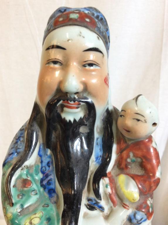 Signed Asian Male Porcelain Figure W Baby: Piece depicts a male figure holding a baby. Piece measures approx 17 inches tall 4.5 inches wide. Underside of piece is signed with Asian Characters. Asian Statue, Asian Porcelain. asian arts and craf