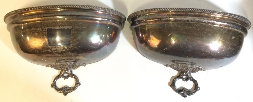 Pair Silver toned Metal Wall Mount Planters: Planters are silver toned and metal. Pieces are possibly silver plated. Lower areas of pieces have ornate detail. Each measures approx 11 inches tall 19 inches wide 7 inches deep. decorative accessory