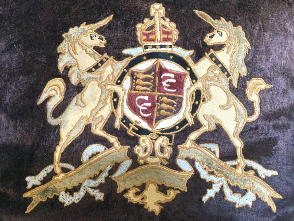 Pair Silk & Velvet Style Pillows W Coat of Arms: Pair of pillows with coat of arms embroidered motifs. Zipper closure on undersides. Interior lining is marked for 100% Rayon, Made In India. Each measures approx 16 inches square. Feather Pillow filli