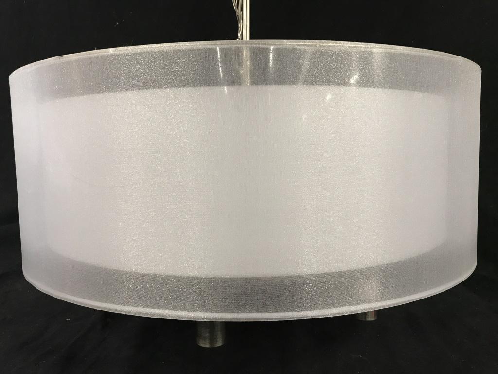 Contemporary Double Drum Shade Chandelier: Contemporary double drum shade chandelier, marked for Pacific Coast Ltg. 6-arm lights in chrome tone, with white tone drum shades. Measures approx 21 inches in height by 22 inches in diameter, not inc