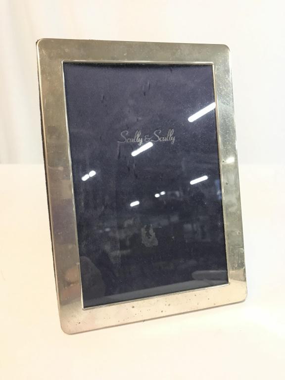 Sterling Scully & Scully Picture Frame: Sterling Scully & Scully Picture Frame, measures approximately 5 inches wide x 7 inches tall, marked on side of frame with Lion, 925, e and two additional hallmarks, needs polishing. Sterling Silver T