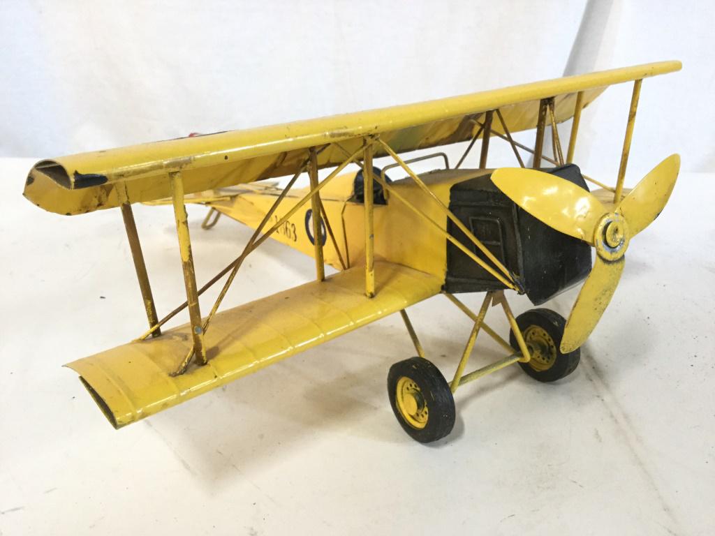 Yellow Toned Metal Model Bi Wing Airplane: Airplane is yellow toned and metal. Piece measures approx 13.5 inches wide 14 inches long 6 inches tall. Piece has evident wear. collectible, model airplane, shelf piece, aviation accessory, collectib