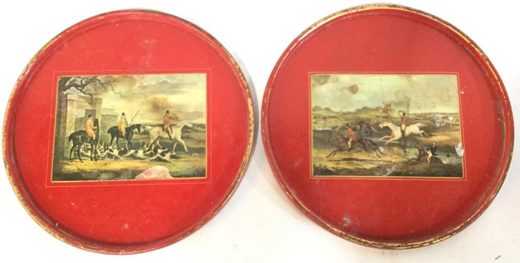 Lot 2 Vintage Round Lacquered Foxhunt Trays: Trays are red toned. Pieces appear to be Lacquered. Pieces have depictions Of fox hunts. Each piece measures approx 14.5 inches wide. Each piece has evident wear. trays, decorative tableware, shelf pi