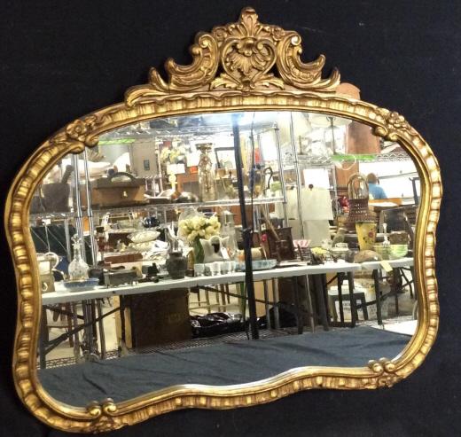 Antique carved gilded mirror: Mirror set in hand carved wooden frame, some chips and damages to frame. Measures appr. 25 inches H and 27.5 inches W. Home decor, mirror, wood, wood frame, hand carved. wall mirror, entryway decor, 9