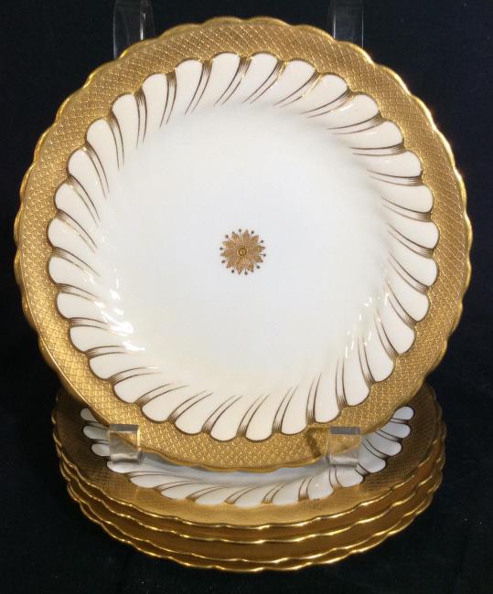 Set 5 English Minton Gilman Collamore & co Plates: Minton Gilman Collamore & Co. 5 plate set. Features golden floral pattern, as well as gilding along plates edge. Plates measure appr. 7.75 inches in diameter. Minton Porcelain Plates, English Fine Chi