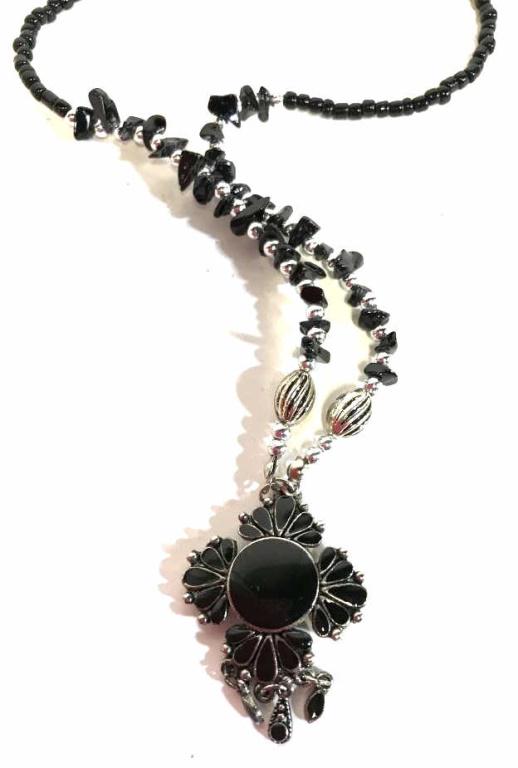 Vintage Style Onyx Pendant & Beaded Necklace: Tassels hang from pendant, shaped into floral motif with silver toned metal and polished onyx inlaid in tear drop shapes with round center stone. Pendant 1 3/4 in. length,1 1/4 in. width. Necklace has