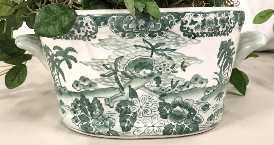 Chinese Ceramic Planter Cache Pot: Chinese Ceramic Planter Cache Pot with white toned background and green painted scene of winged cherubs flying amongst trees and flowers, marked on underside with asian characters imitation silk flowe