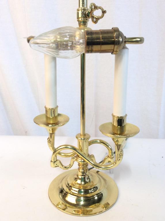 Gold Toned Candlestick Style Lamp: Lamp is gold toned, possibly brass. Contains 2 bulb sockets and 2 Candlestick arm style structures. Piece includes finial. Measures approx 23 inches tall 8 inches wide. candlesticks, home decor, home 