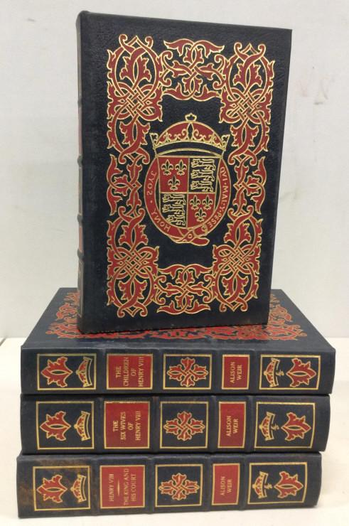 Group Lot ALISON WEIR historical works: Collection of historical writings by Alison Weir. Each book is decorated with a coat of arms embossed in gold, the pages are gilded. The largest piece measures approx. 9.5 inches H, 6.5 inches L, and 
