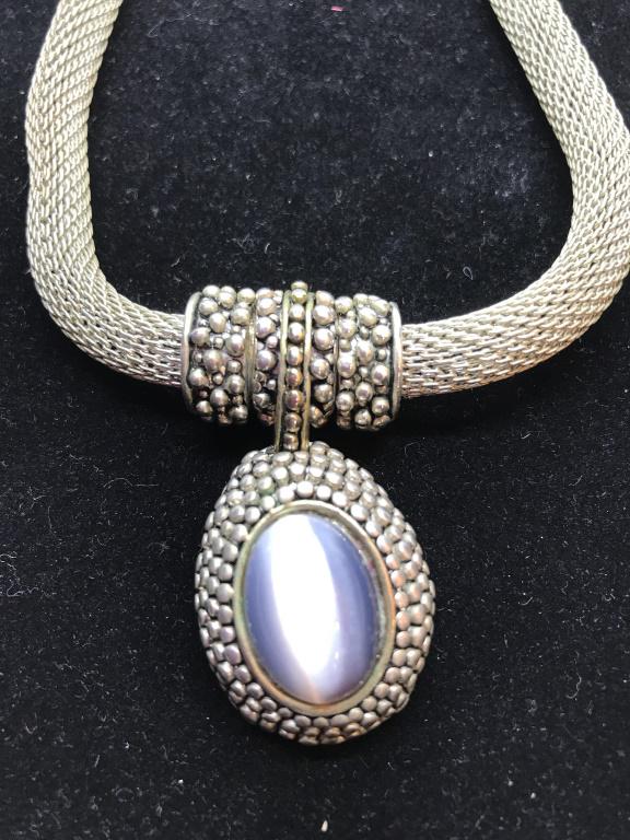 Moonstone Pendant on Mesh Chain: Sizable tubular mesh chain, app 8 mm wide. Button decor on silver tone metal with matching bail. Hidden clasp is magnetized. Pendant, possibly moonstone, hangs 1 1/4 in. Comes in box that is not origi