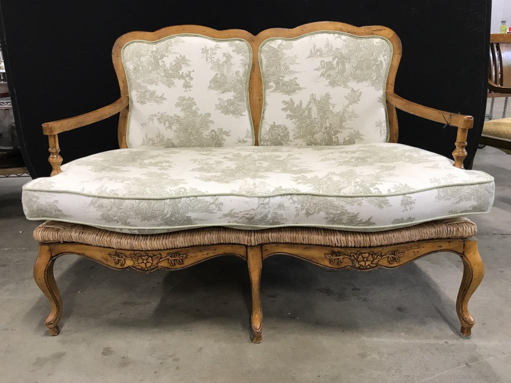 Country French Provincial Style Rushed Seat Settee: Country French Provincial Style Rushed Seat Settee with sea foam green on cream toile fabric and green welted trim. Carved wooden pine toned frame with rushed seat. Some minor chips and surface scratc