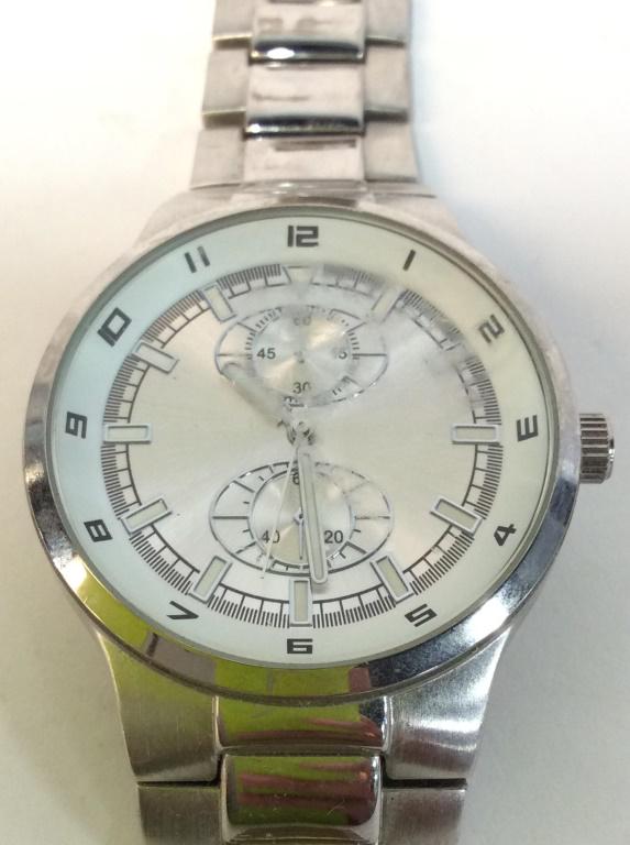 JAPAN MOVEMENT Silver Toned Mens Wristwatch: Backside is marked JAPAN MOVEMENT. Piece is silver toned. Wrist band measures approximately 8 inches long watch face 1.75 inches wide. mens fashion accessories and wearables 6