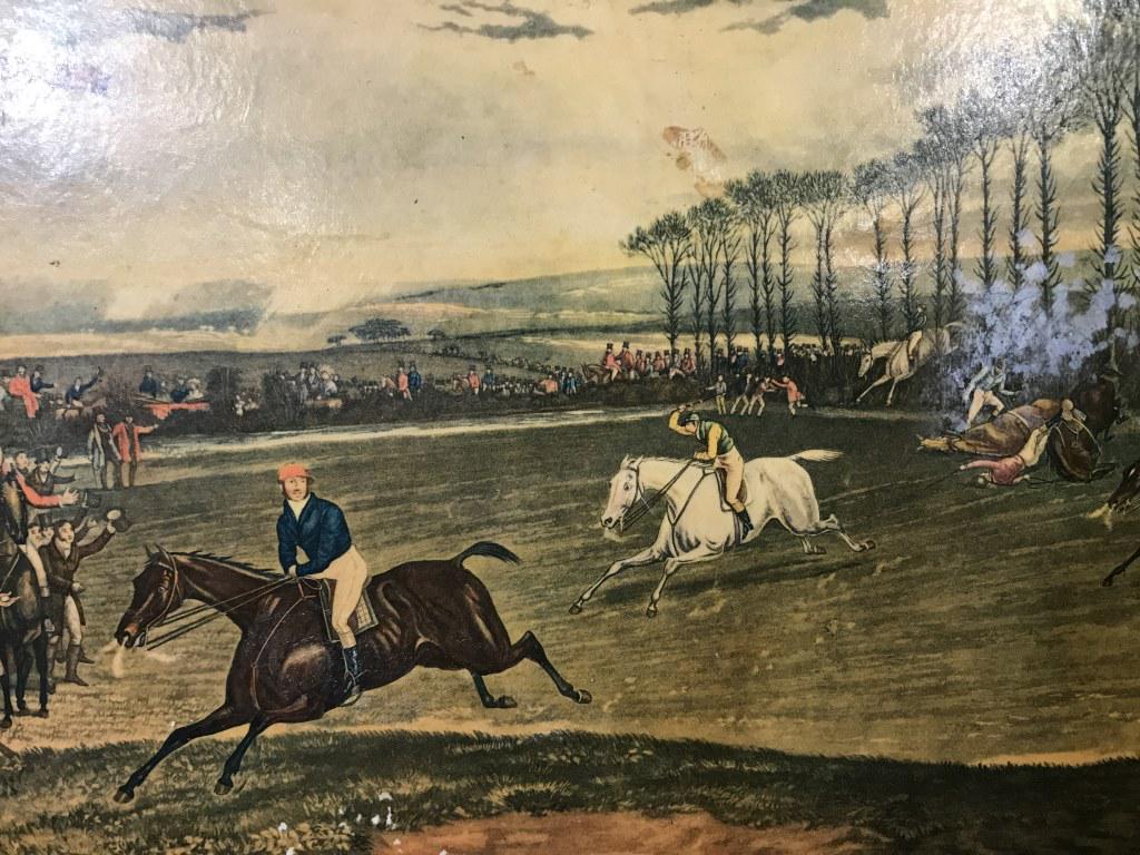 Steeple Chase Lacquered Decorative Serving Tray: Serving Tray is red toned with gold toned accent detail. Piece depicts VALE OF AYLESBURY STEEPLE CHASE. Piece has handles. Measures approx 18 inches long 12 inches deep. fox hunt, lacquer wood, decora