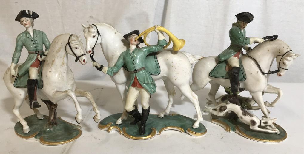 Vintage Porcelain Hunting Party Figurines: Vintage, possibly antique, porcelain figurines. The group of figurines depict a hunting party and hunting dogs. Possibly crafted Nymphenberg Porcelain company in Germany. The largest piece measures ap