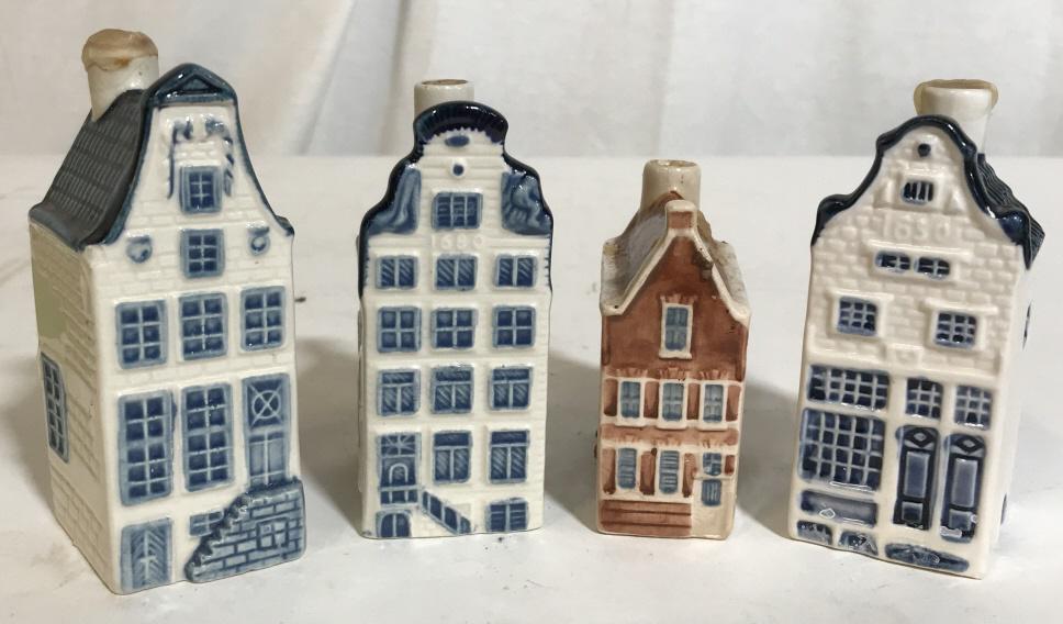 Set 4 Vintage Blue Delft House Bottles: Blue delft houses lot. Several of the houses were provided by KLM for distilleries in Holland. Some sealing still present. The largest piece measures 3.75 inches H, and 1.5 inches W. KLM, BLUE DELFT, 