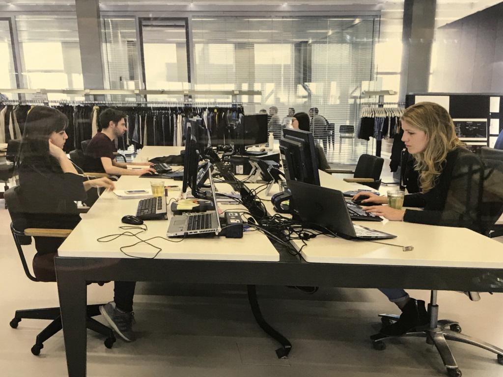 Framed Lithograph, Scandi Co-Working Interior: Framed Lithograph Of Photograph Of interior of Scandinavian style working environment. Possibly an offset lithograph. Print is set behind plexiglass in white tone wood frame. Measures approx 16.5 inch