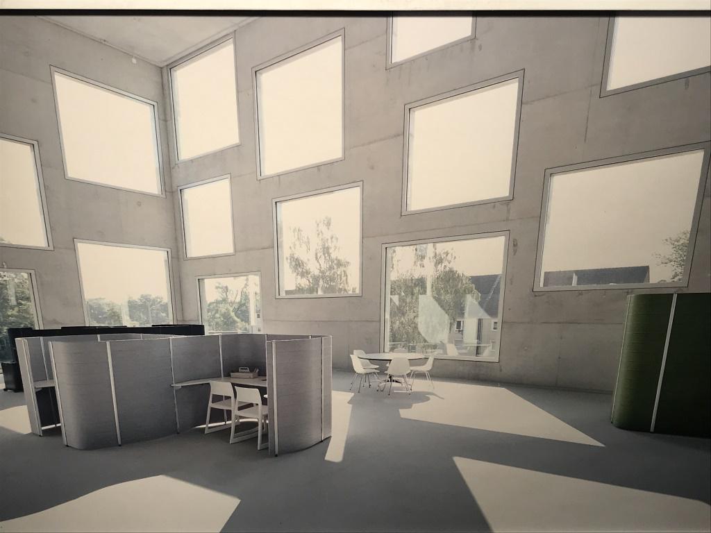 Framed Lithograph, Scandi Co-Working Interior: Framed Lithograph Of Photograph Of interior of Scandinavian style working environment. Possibly an offset lithograph. Print is set behind plexiglass in white tone wood frame. Measures approx 16.5 inch