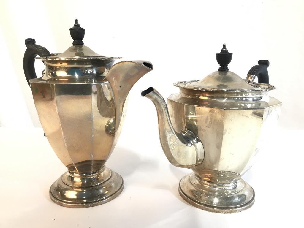 Lot 2 Vintage Metal Coffee Pot & Tea Pot: Lot includes 1 coffee pot & 1 teapot. Each are silver toned and metal. Each have black toned handles. Each are Lidded. Tallest piece measures approx 9 inches tall 8.5 inches wide with handle and spout