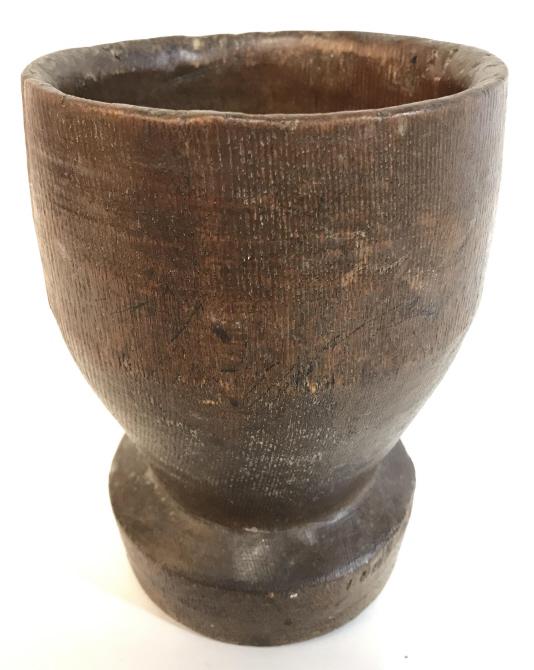 Vintage Carved Wooden Footed Mortar: Mortar is brown toned and wooden. Piece is possibly hand carved. Piece is footed. Measures approximately 7.5 inches tall 4.5 inches wide. tableware, mortar, kitchen accessories, apothecary accessory, 