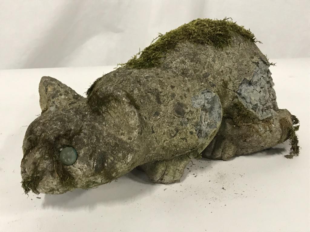 Outdoor Stone Composite Cat Figural: Stone composite outdoor garden cat Figural sculpture. Measures approximately 4.5 inches in height by 11.5 inches in length. Figurine has substantial wear like cracking and moss growth. Outdoor garden 