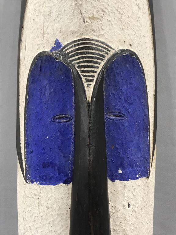 African Art 3ft 8in Fang Tribe Wood Mask, Gabon: African Fang Tribe extra long wooden mask from Gabon, Central Africa. Mask features white, blue, orange, and honey toned painted wood. Measures approx 44 inches in length by 5.25 inches in width by 3.