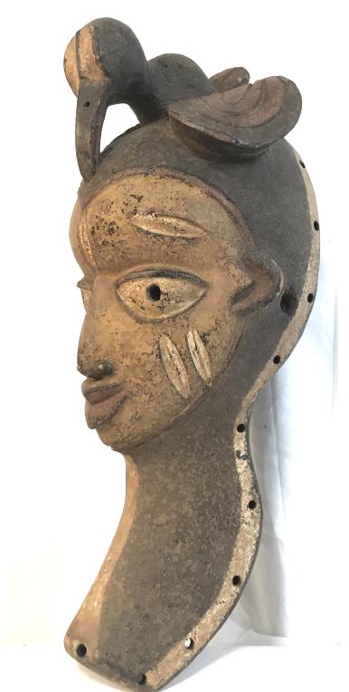 African Art Yoruba Tribe Ceremonial Dancing Mask: African Art Dancing Mask from the Yoruba People in Nigeria, West Africa. Mask with large eyes, and geometric details on cheeks, temples, forehead, along with elaborate coiffure stylized as bird. Mask 