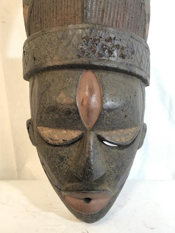 African Art Yoruba Ceremonial Wedding Mask: African Art Wedding Mask from the Yoruba People in Nigeria, West Africa. Mask with incised eyes, and geometric details on cheeks, temples, forehead, along with horn-like details. Mask is carved wood w