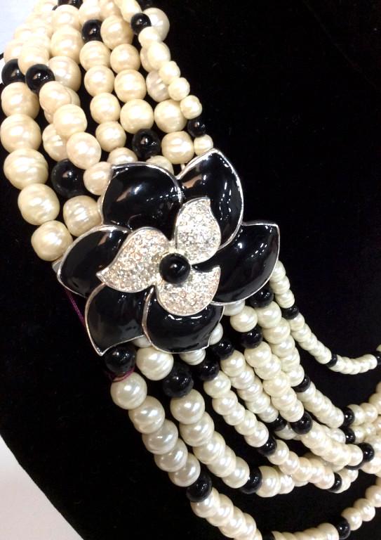 CAROLEE White & Black Cascading Statement Pearls: Care of Ralph Lauren/Carolee Head Jewelry Designer Showroom Inventory. Choker Necklace. Labeled ‘Carolee’ on underside of clasp hardware. Magnetic clasp with large Enameled Black Floral, encrusted